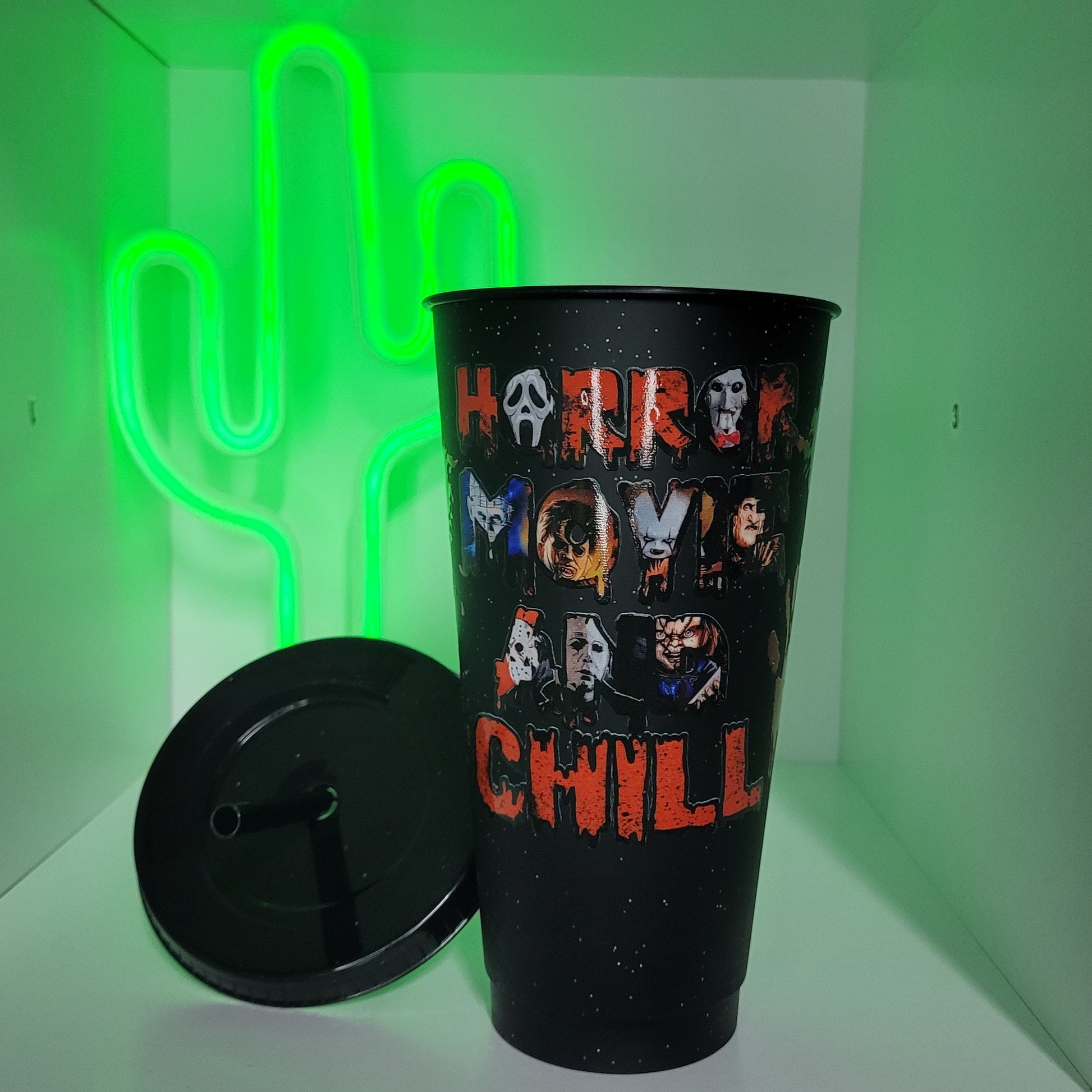 Black plastic tumbler with straw horror movie and chill