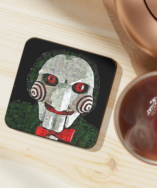 Drink coaster table set up with tea and teapot. The coaster featured Jigsaw from the Saw movies